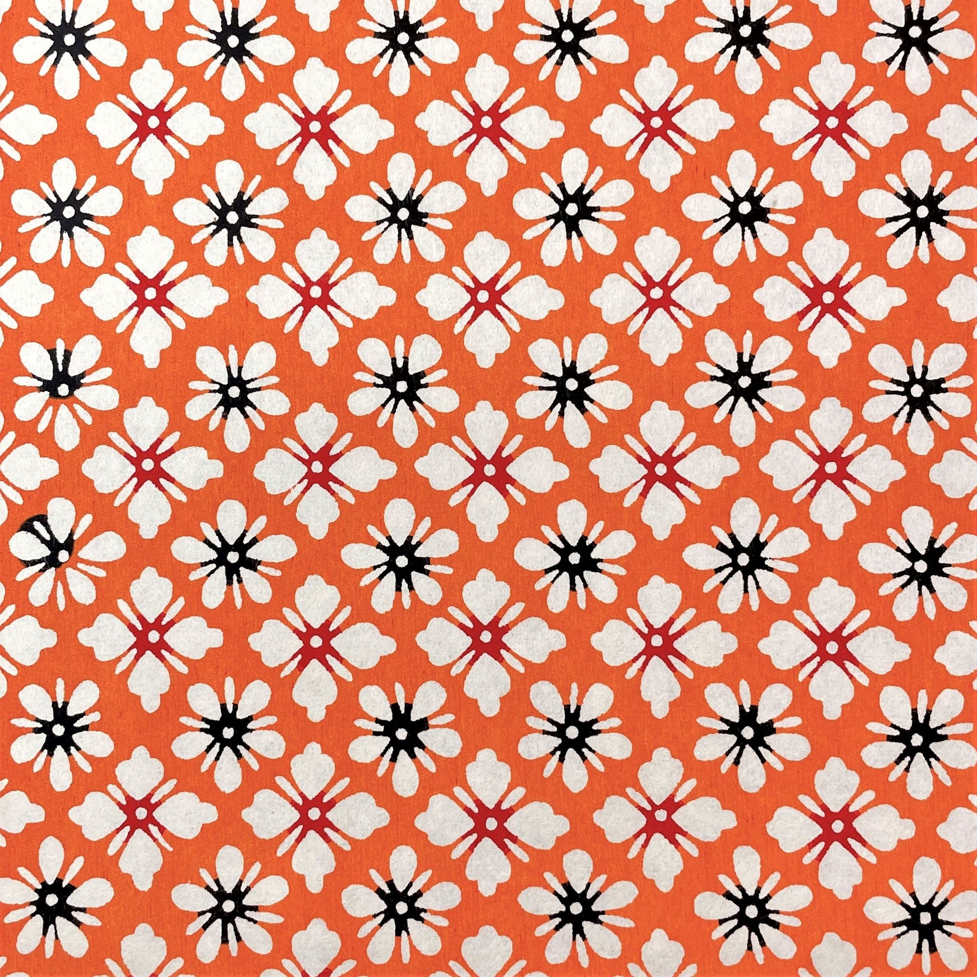 japanese stencil-dyed handmade paper with small scale floral repeat in orange and cream