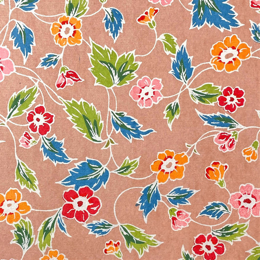 japanese stencil-dyed handmade paper with delicate repeat multi colour floral pattern on blush backdrop
