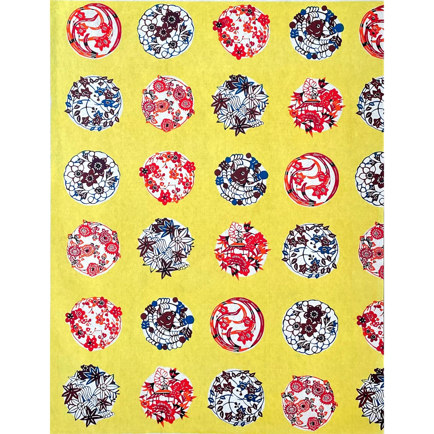 japanese stencil-dyed handmade paper with traditional botanical circles pattern on yellow backdrop, full sheet view