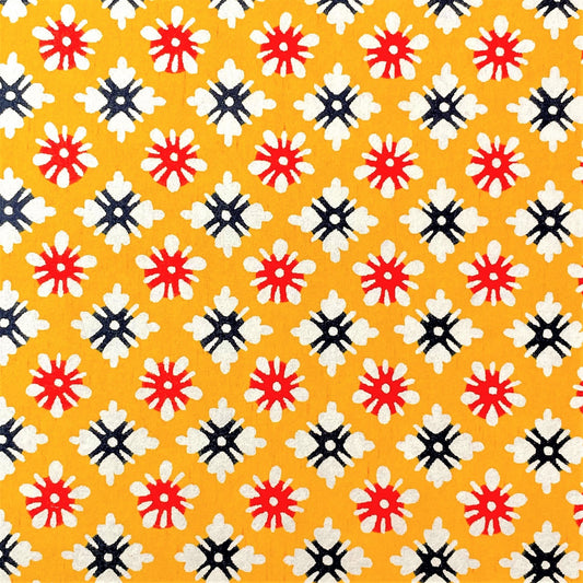 japanese stencil-dyed handmade paper with small scale floral repeat pattern on yellow backdrop