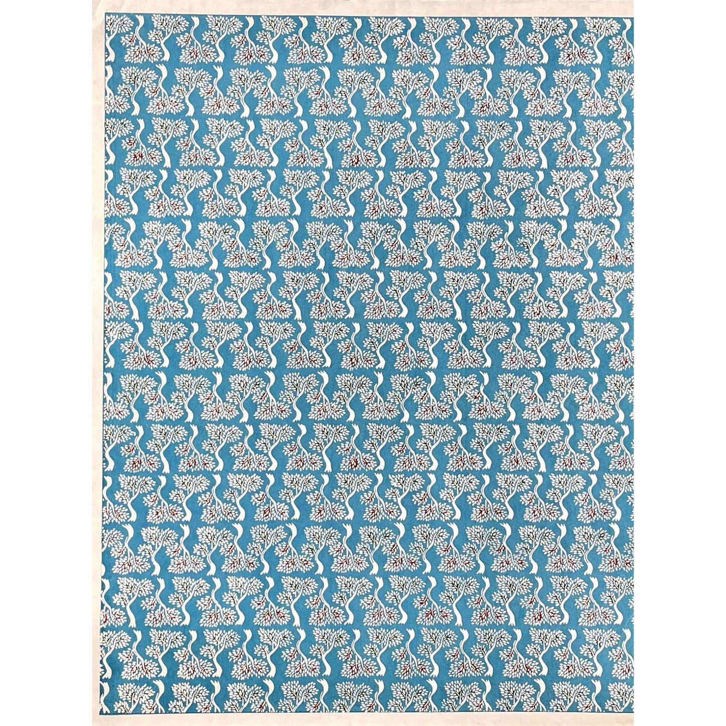 japanese stencil-dyed handmade paper with bonsai tree repeat pattern on blue backdrop, full sheet view