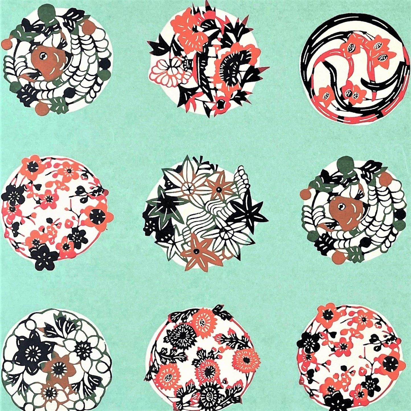 japanese stencil-dyed handmade paper with traditional botanical circles pattern on aqua backdrop