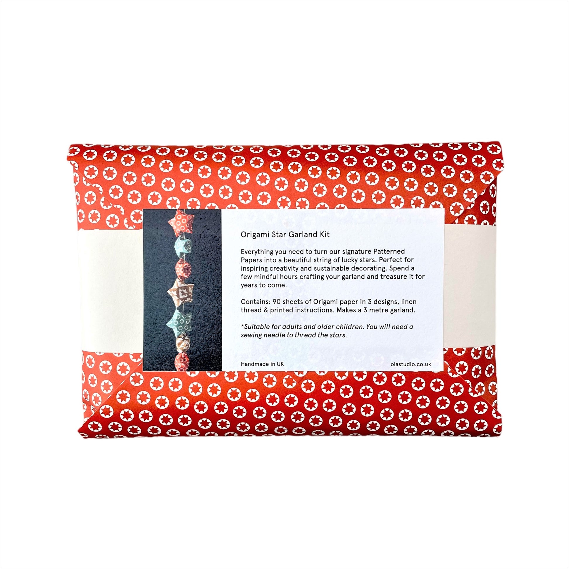 A garland of small paper origami patterned stars "lucky stars" , pictured is the reverse of the outer red envelope packaging showing contents