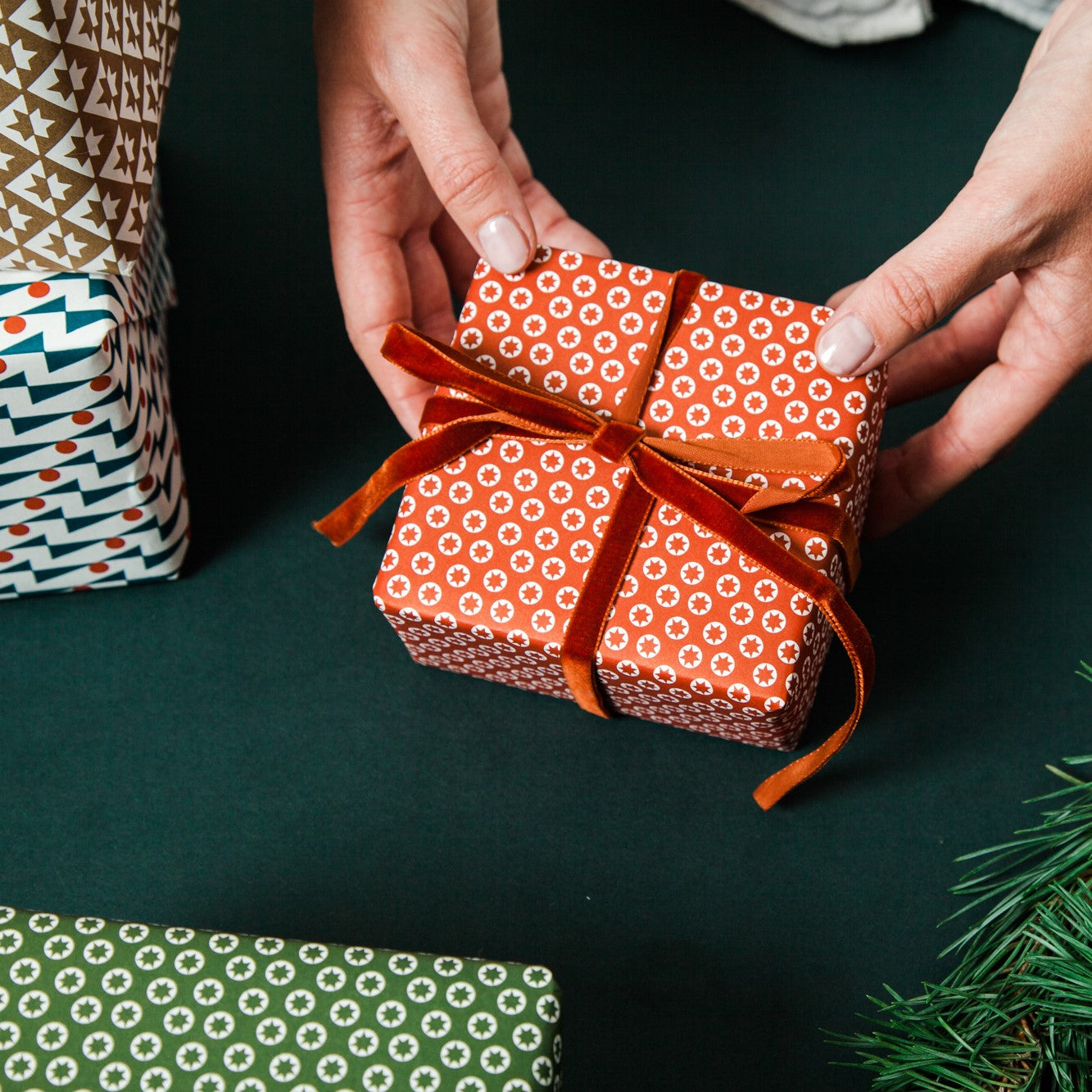 wrapping paper with an abstract tiny stars pattern in red and white, pictured wrapped present