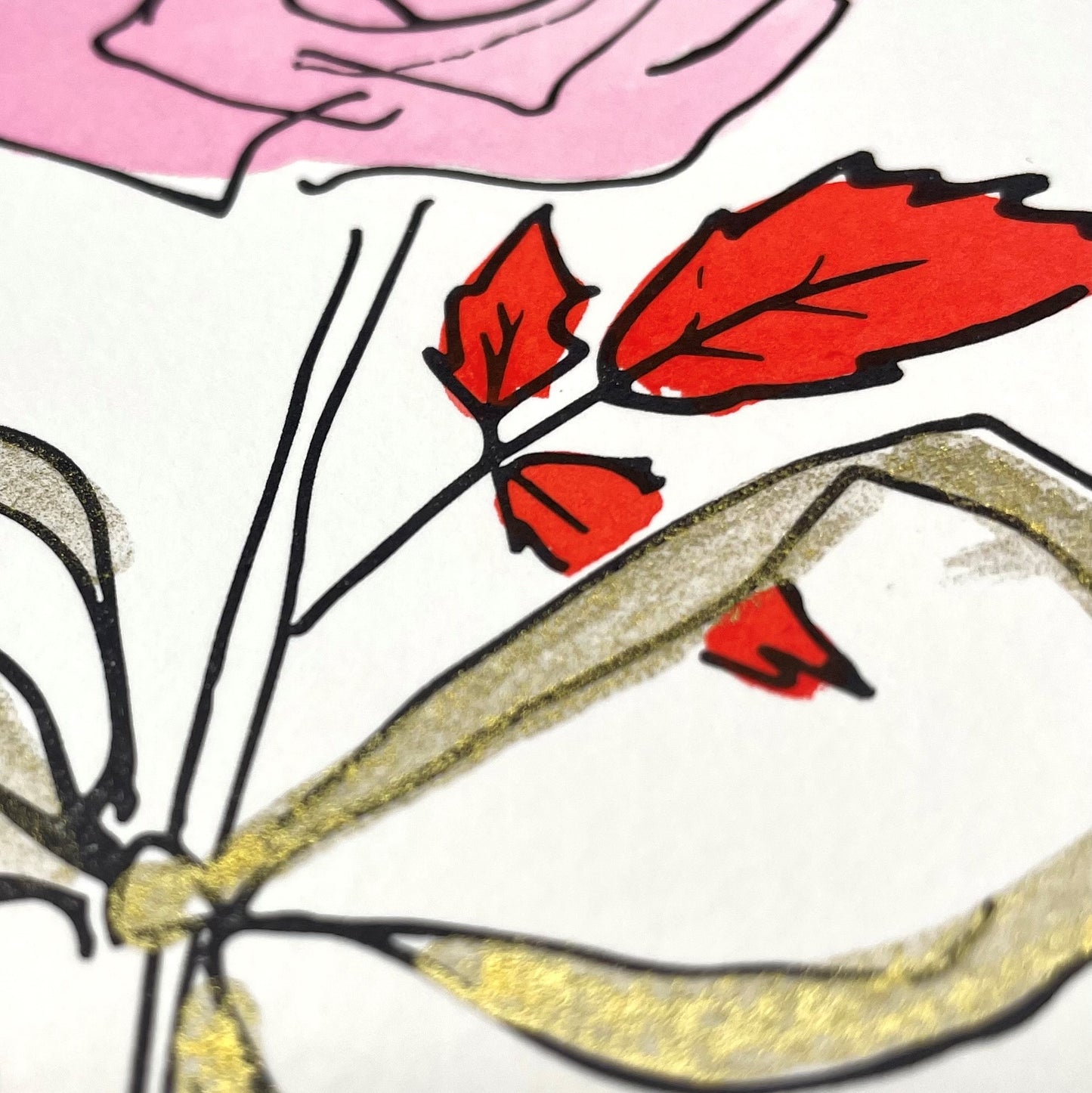 hand-painted greetings card of a pink rose tied with a gold ribbon, close-up