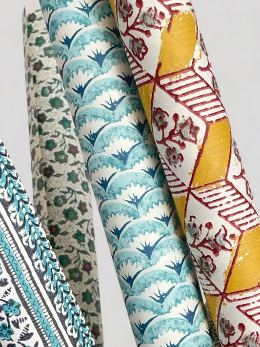 Italian rolls of patterned wrapping papers in yellows and blues