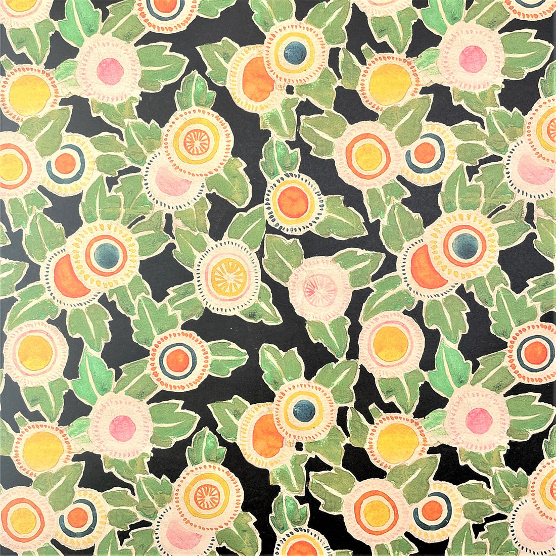 Floral patterned paper, black backdrop with green foliage and yellow, pink and orange flowers