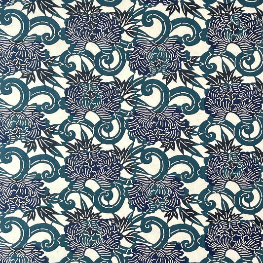 Image of a Japanese stencil-dyed paper - katazome-shi - with a botanical repeat design in inky blues on a cream backdrop