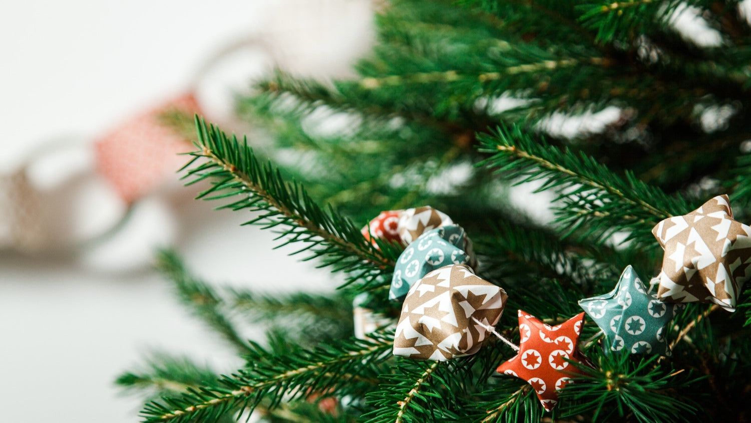 image of festive paper stars on a christmas tree