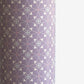 Patterned wrapping paper with geometric design on a purple background
