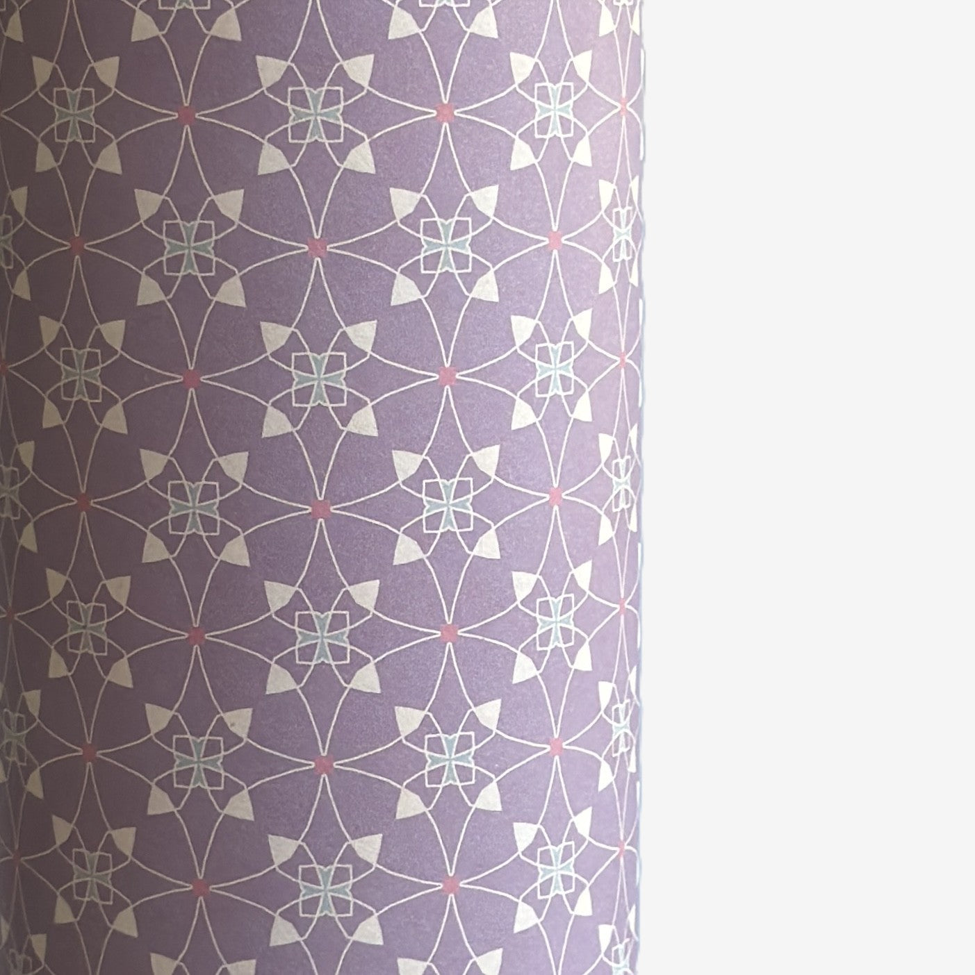 Patterned wrapping paper with geometric design on a purple background