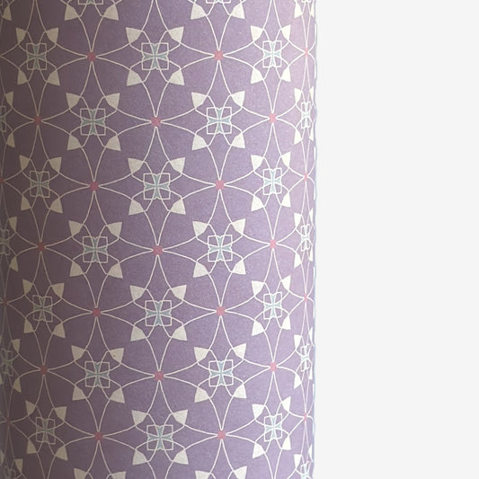 Patterned wrapping paper with geometric design on a purple background