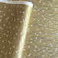 Japanese silkscreen chiyogami paper with a pattern of purple arches and white cherry blossom on antique gold backdrop