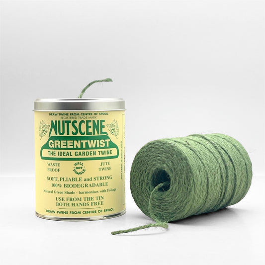 A tin of twine by Nutscene, tin pictured alongside the spool of green jute twine