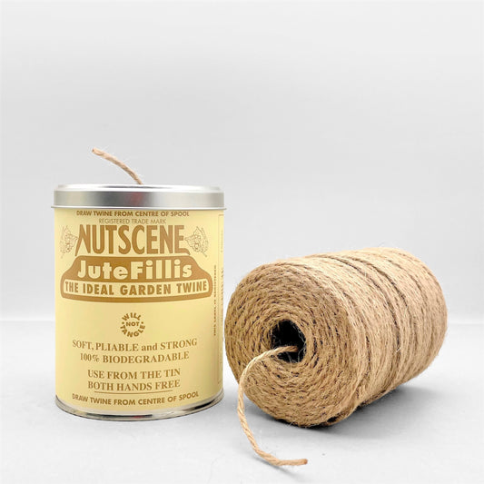 A tin of twine by Nutscene, tin pictured alongside the spool of  natural beige jute twine