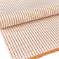 wrapping paper with an abstract circle pattern in orange and pale pink by Ola Studio