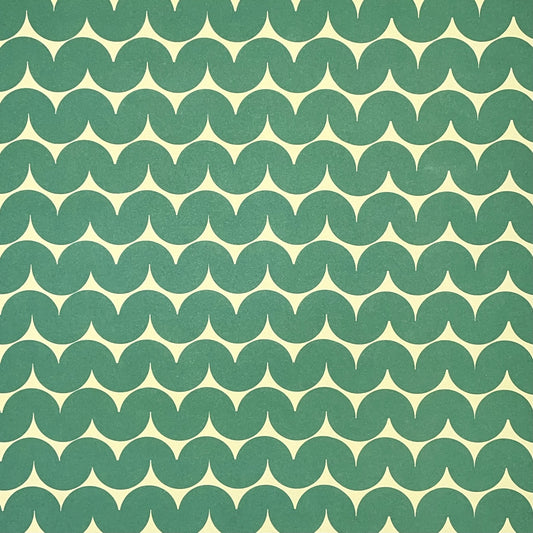 wrapping paper by Anne Davison Studio. Bold green wiggle lines with a retro vibe on beige backdrop.
