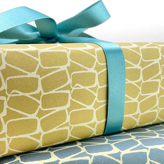 wrapping paper by Anne Davison Studio. Creamy domino outlined shapes on a mustard background. close up