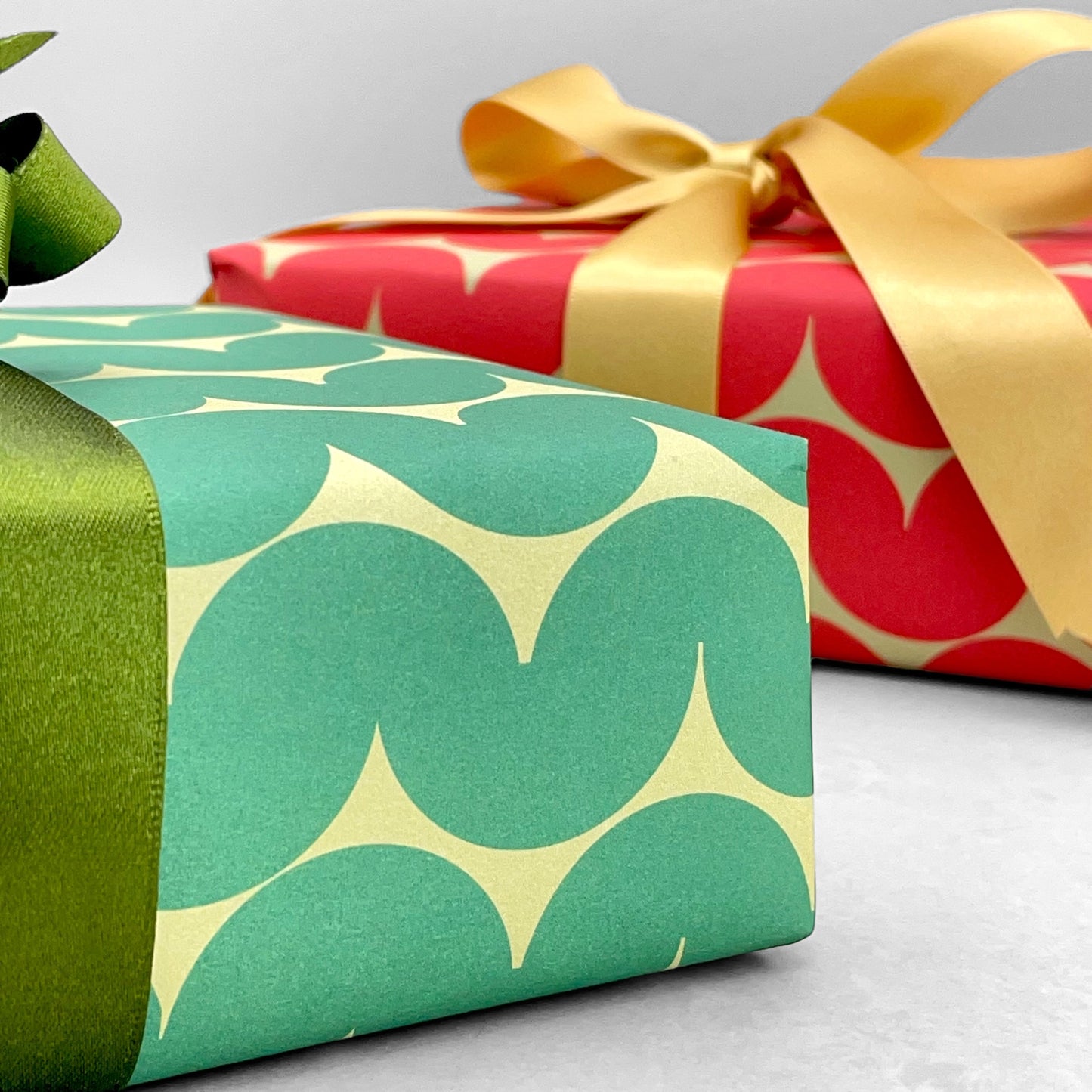 wrapping paper by Anne Davison Studio. Bold green wiggle lines with a retro vibe on beige backdrop.  Close up
