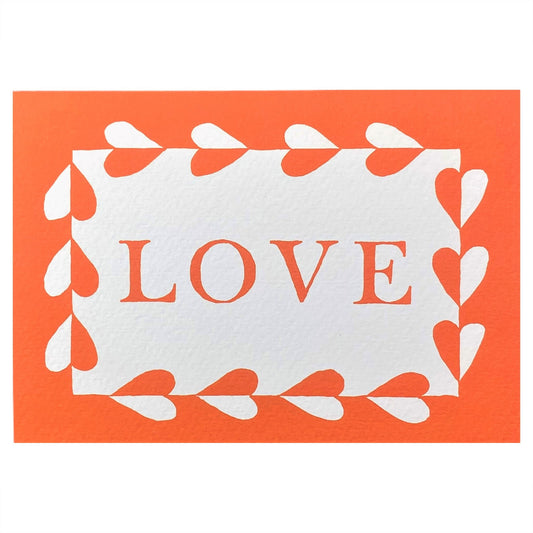 Greetings card with the word LOVE written and a border with hearts in deep orange on a white background. By Ariana Martin