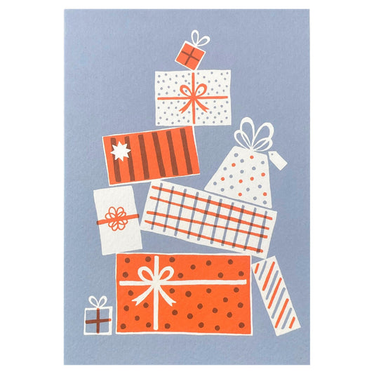 Greetings card of a pile of presents in red and white patterns on a blue backdrop.  christmas card by Ariana Martin
