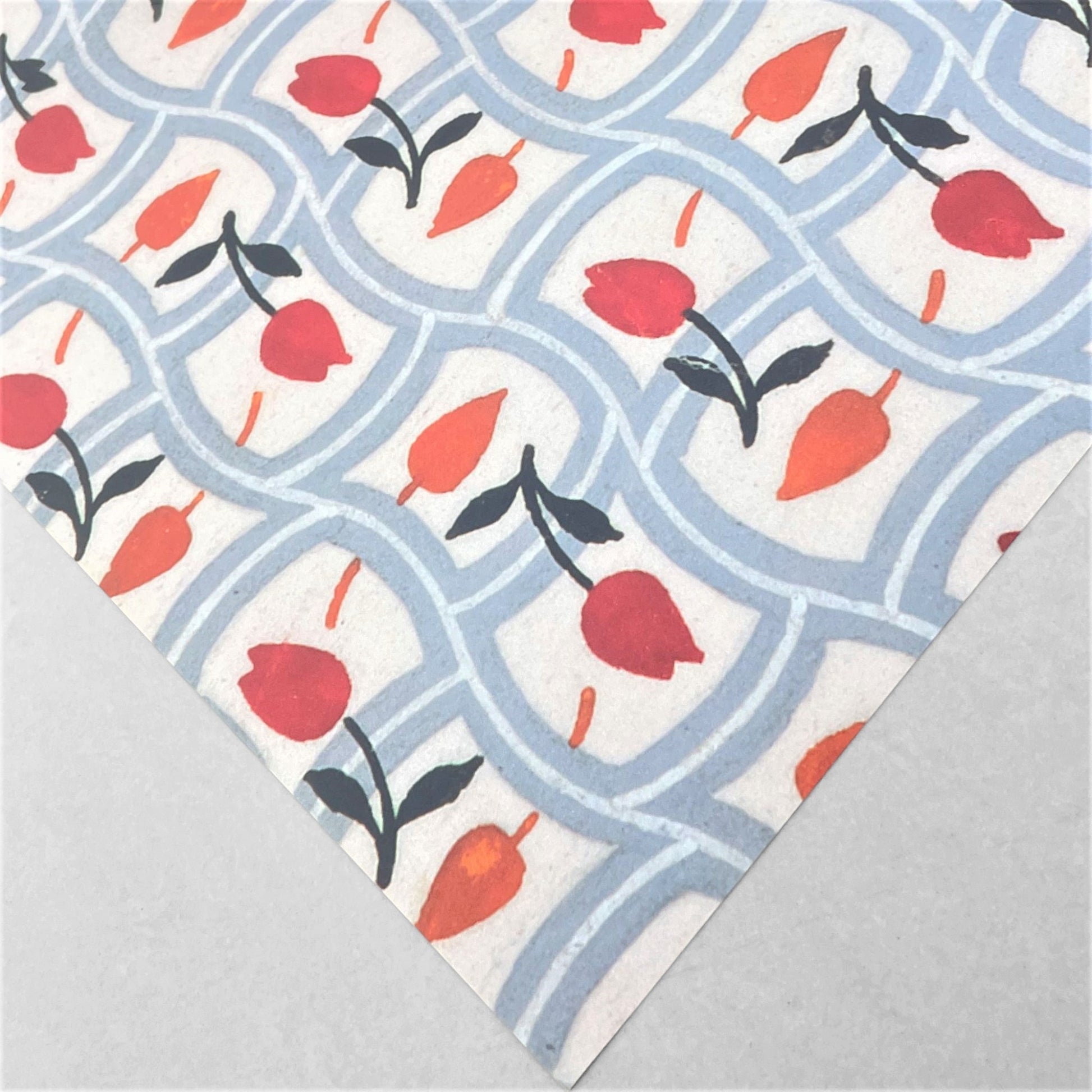 wrapping paper with repeat pattern on red tulips on a duck egg wavy grid backdrop by Artisan Deesign. Design Silver Studio