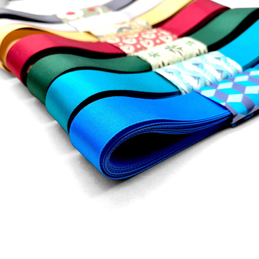 Satin ribbon 25mm wide and 5 metres long, presented with a patterned paper band. colour - royal blue