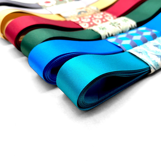 Satin ribbon 25mm wide and 5 metres long, presented with a patterned paper band. colour - teal