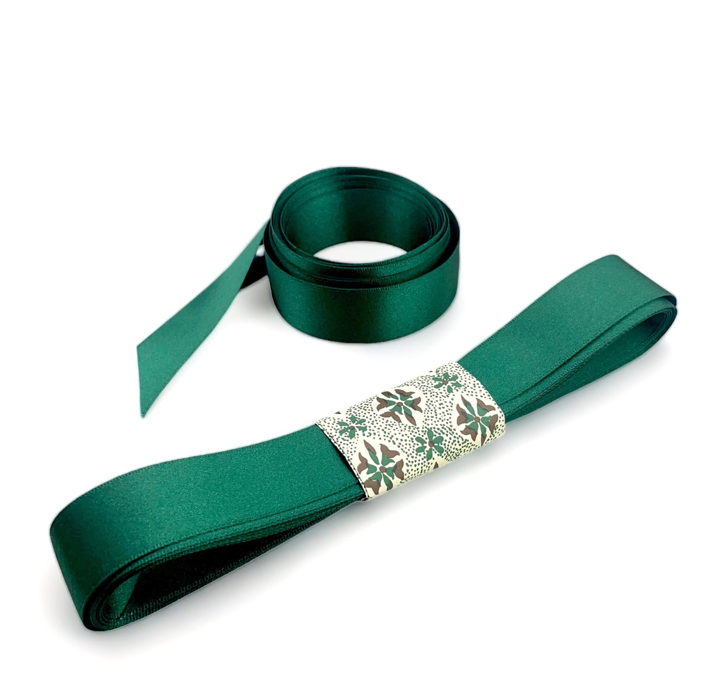 Satin ribbon 25mm wide and 5 metres long, presented with a patterned paper band. colour - forest green