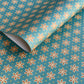 a sheet of wrapping paper with a repeat pattern of stylised brown flowers on a teal green background