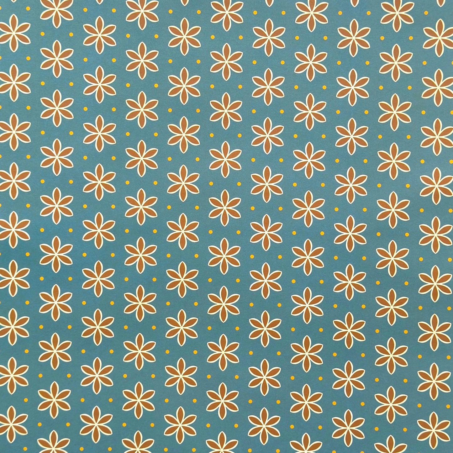 a sheet of wrapping paper with a repeat pattern of stylised brown flowers on a teal green background