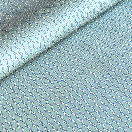 wrapping paper with a geometric zigzag design in aqua, blue and white