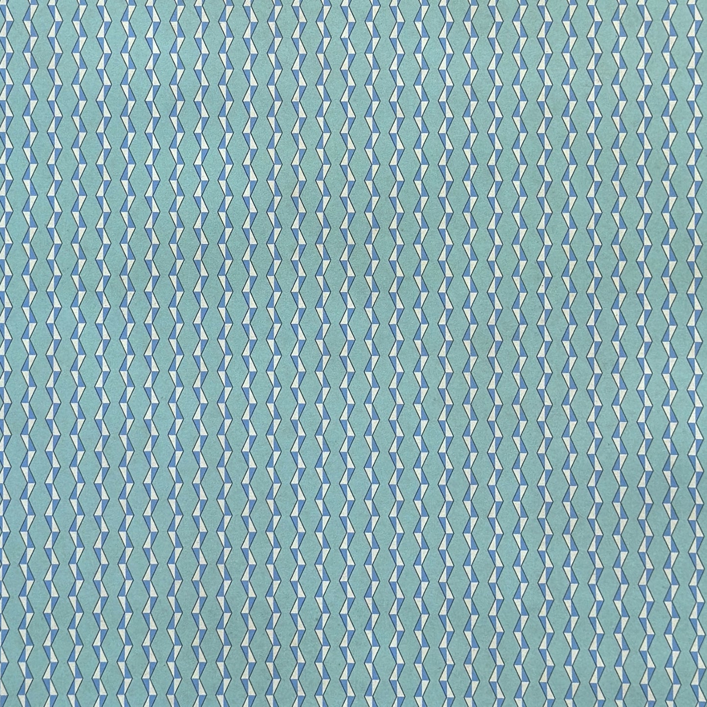 wrapping paper with a geometric zigzag design in aqua, blue and white