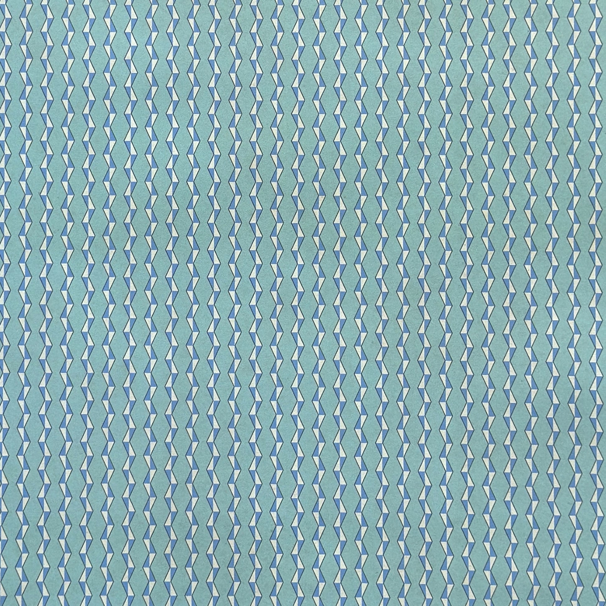 wrapping paper with a geometric zigzag design in aqua, blue and white