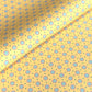 a sheet of wrapping paper with a yellow background and colorful blue circles pattern
