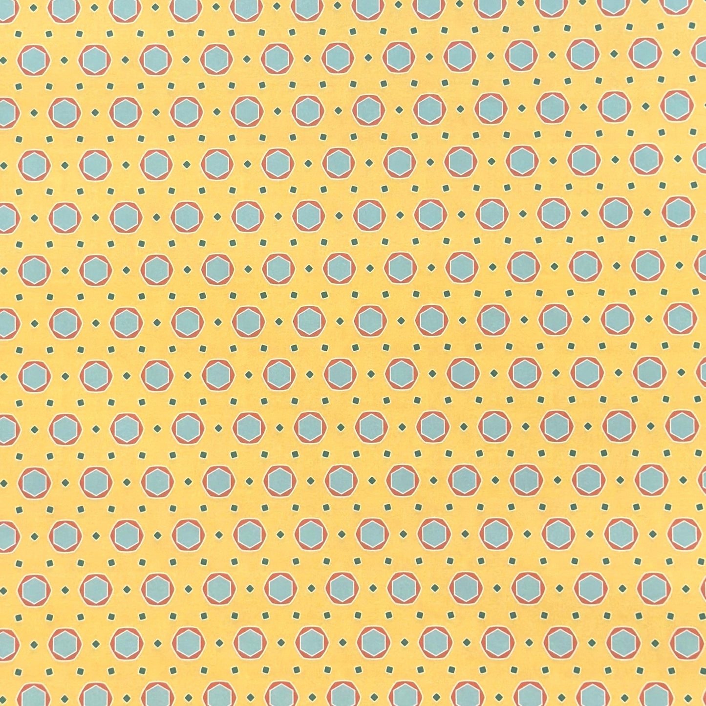 a sheet of wrapping paper with a yellow background and colorful blue circles pattern