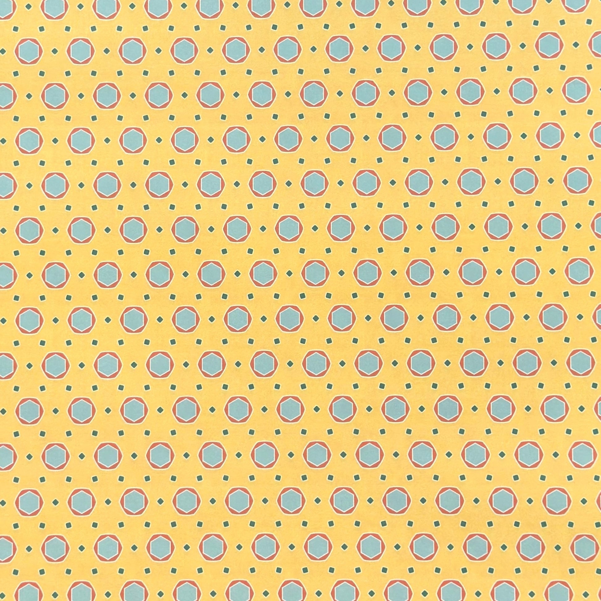 a sheet of wrapping paper with a yellow background and colorful blue circles pattern