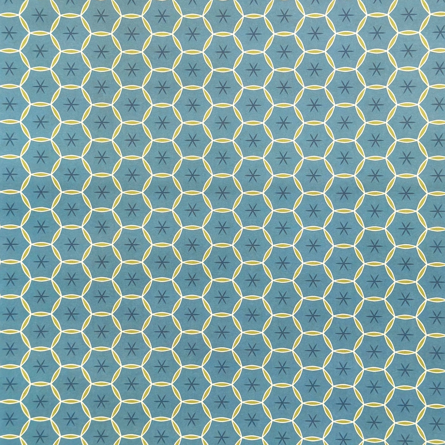 abstract wrapping paper with a geometric circle pattern with a star in the middle in teal blue and lime green