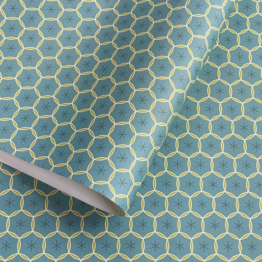 abstract wrapping paper with a geometric circle pattern with a star in the middle in teal blue and lime green