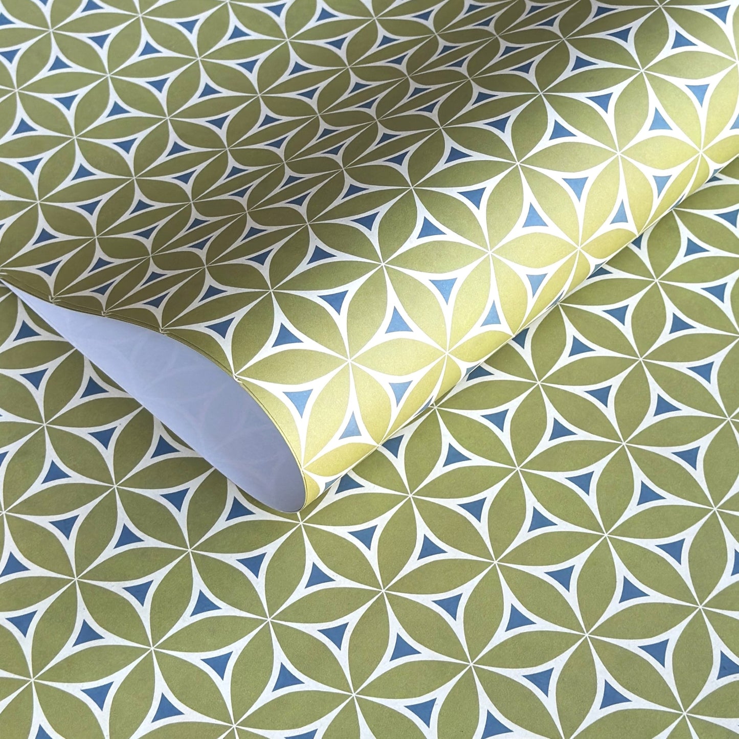 abstract wrapping paper with a geometric flower  pattern in lime green, teal blue and white