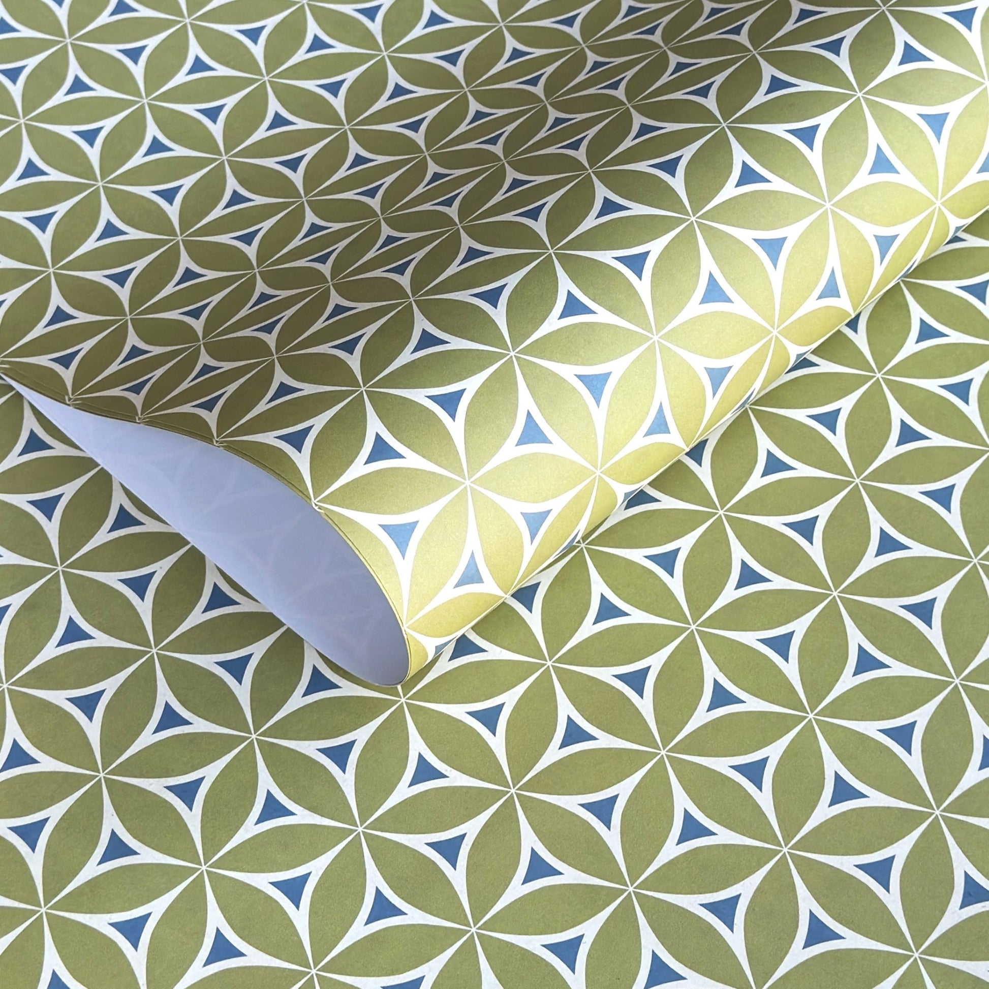 abstract wrapping paper with a geometric flower  pattern in lime green, teal blue and white