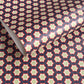Patterned paper with red, green, and white stars on a blue background