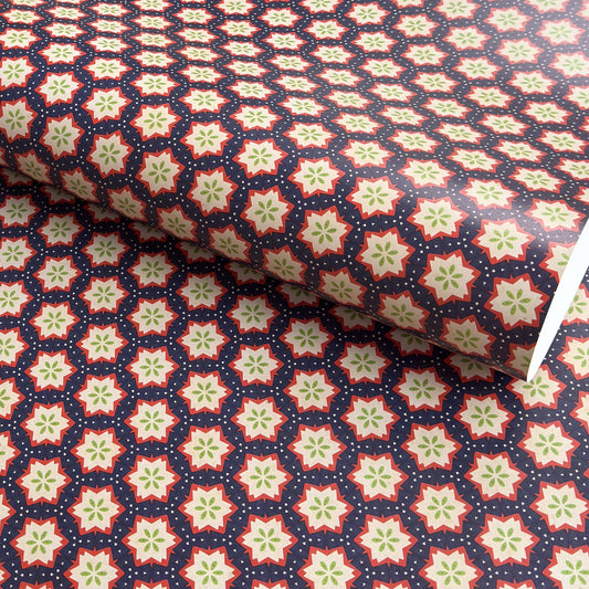 Patterned paper with red, green, and white stars on a blue background