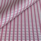 a sheet of wrapping paper with a zigzag pattern in lilac and green on a purple background
