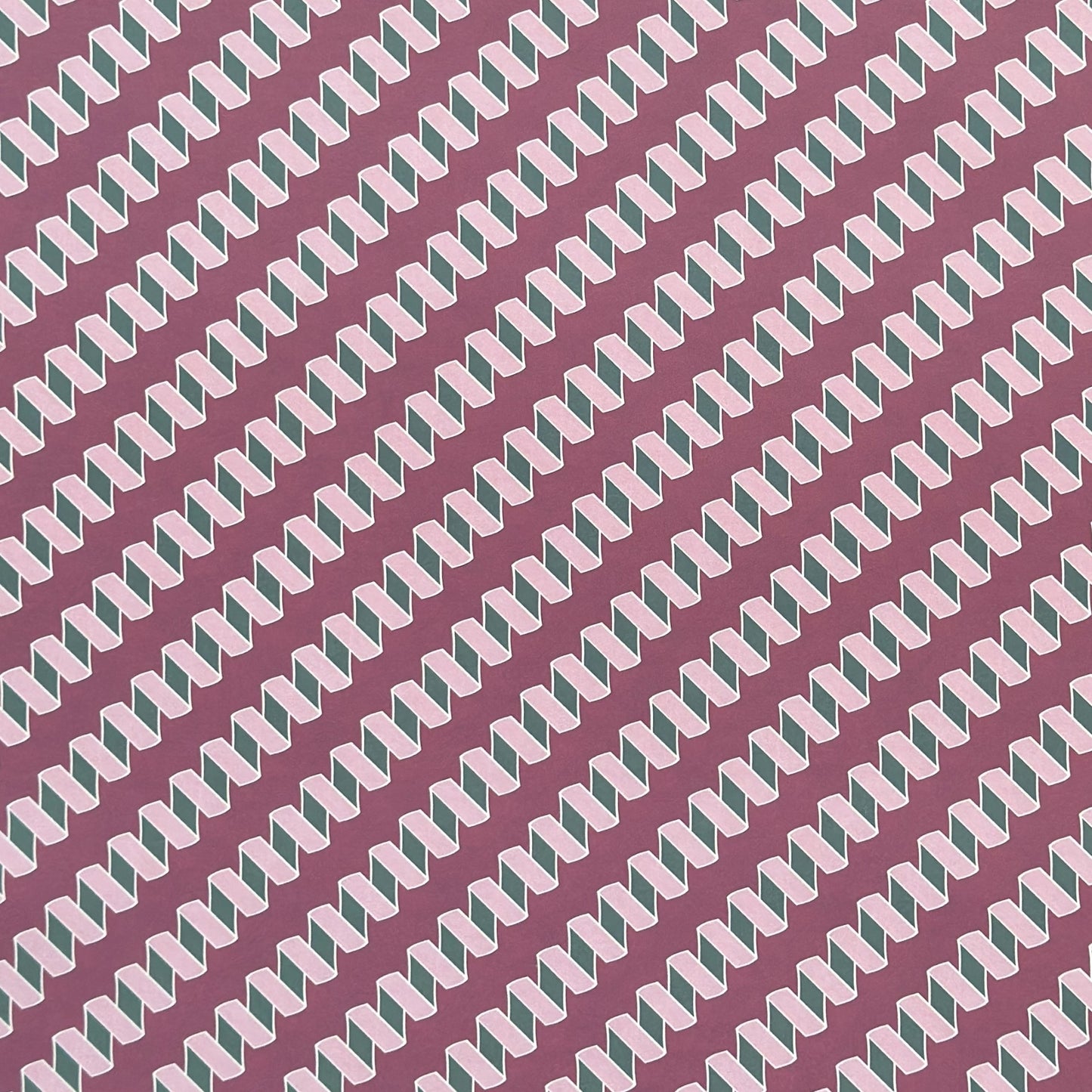 a sheet of wrapping paper with a zigzag pattern in lilac and green on a purple background