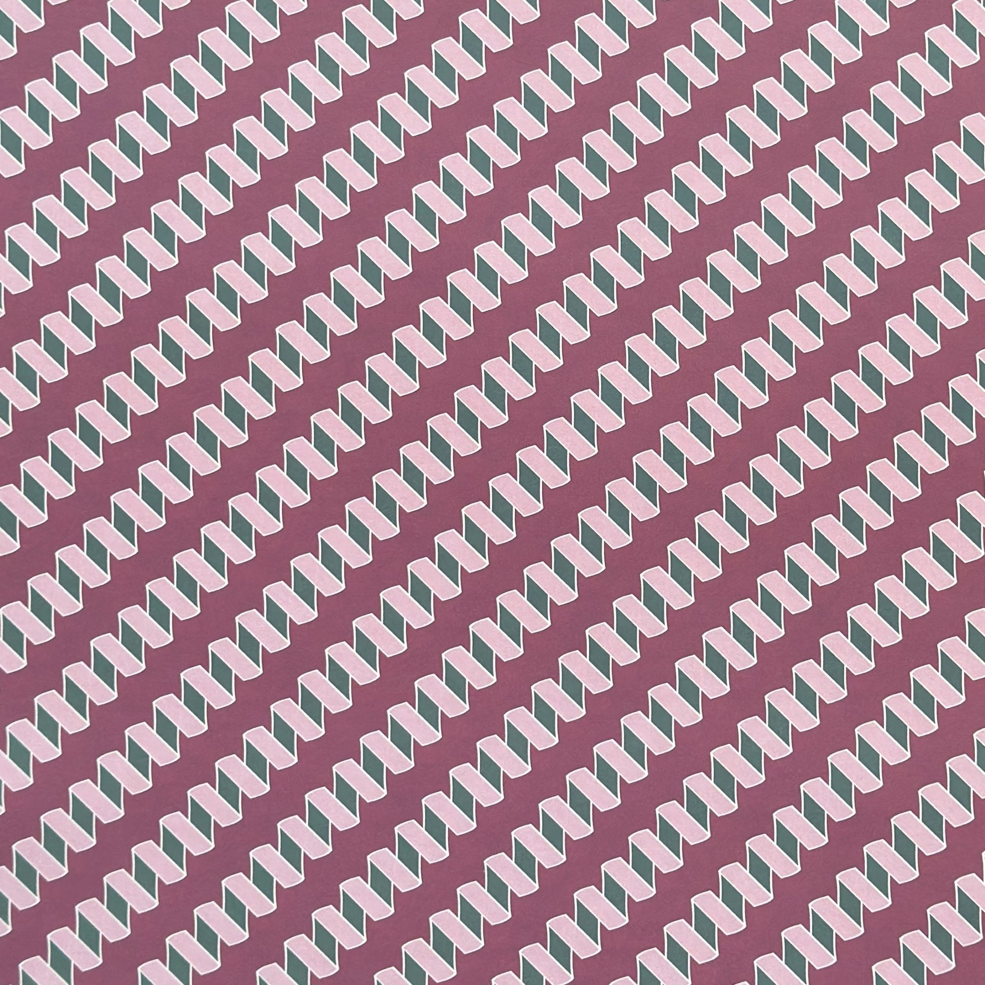a sheet of wrapping paper with a zigzag pattern in lilac and green on a purple background