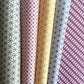 Collection of patterned paper rolls with geometric designs.