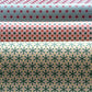 Three rolls of wrapping paper with geometric patterns in different colors.