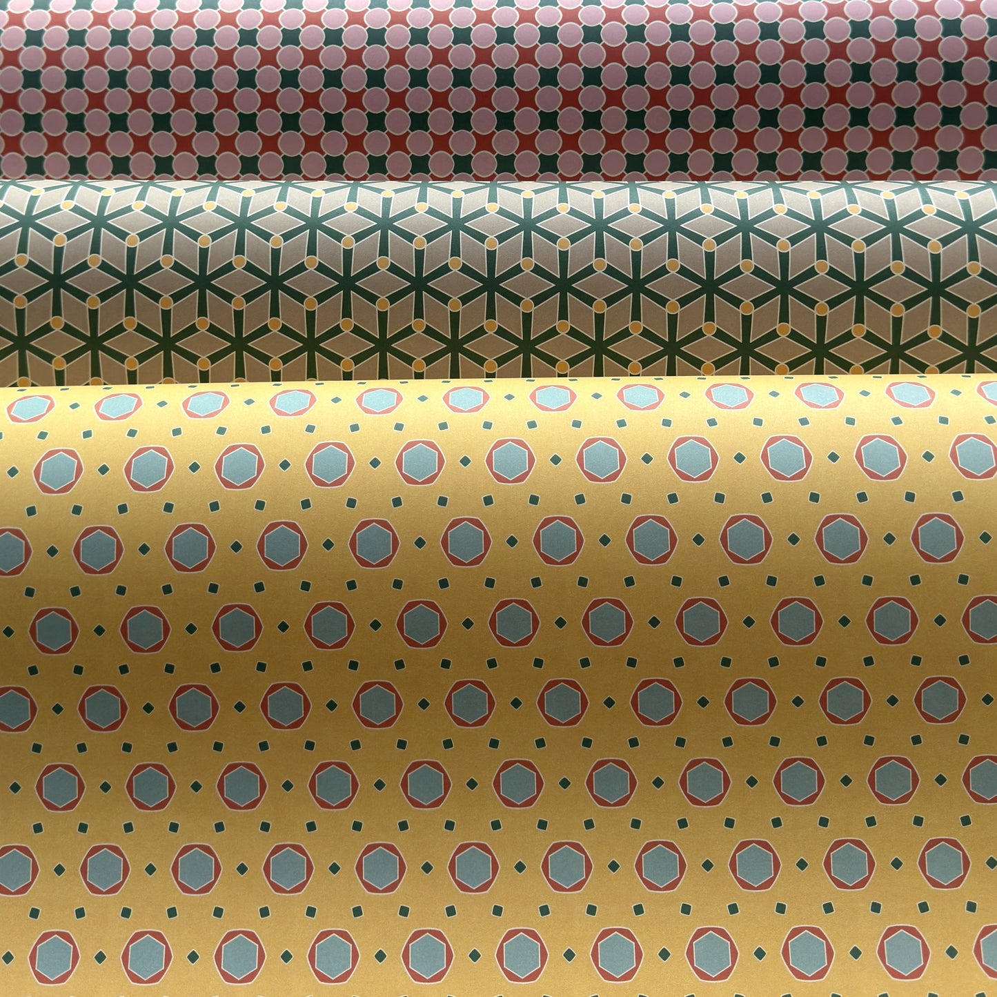 Three rolls of patterned paper with different designs.