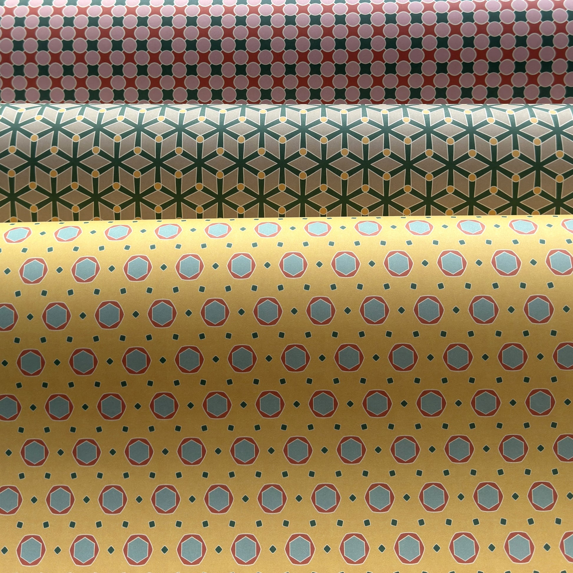 Three rolls of patterned paper with different designs.
